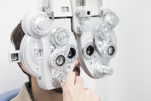 Man at the optometrist making an eye test - ERLF000122