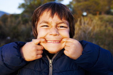 Portrait of little boy pulling funny faces - VABF000133