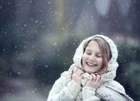 Portrait of happy young woman wearing knitwear in winter - NIF000076