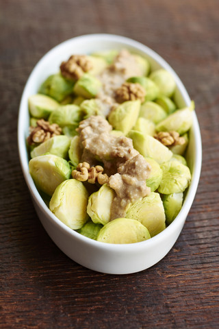 Brussels sprouts with a lemon walnut miso sauce stock photo