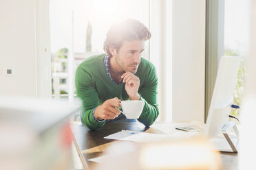 Young man working at home office - UUF006508