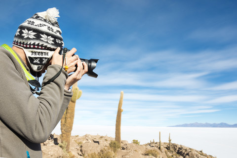 Bolivia, Atacama, Altiplano, Salar de Uyuni, man taking pictures stock photo