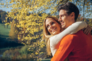 Happy couple embracing in autumn forest - CHAF001568