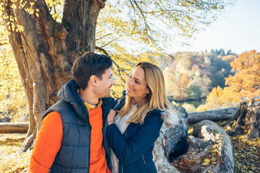 Happy couple enjoying autumn in a forest - CHAF001575