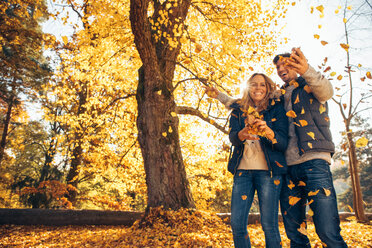 Happy couple having fun in autumn in a forest - CHAF001588