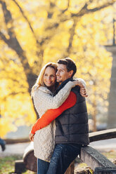 Happy couple enjoying autumn in a park - CHAF001603
