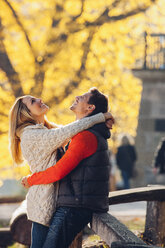 Happy couple enjoying autumn in a park - CHAF001631