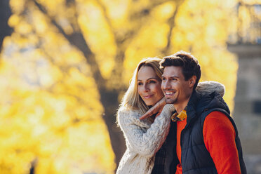 Happy couple enjoying autumn in a forest - CHAF001637