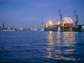 Germany, Hamburg, Harbour, Containership in a dock in the evening - KRPF001721