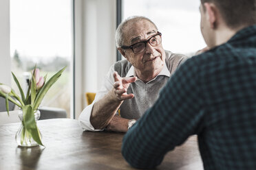 Portrait of senior man communicating with his grandson - UUF006578