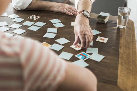 Senior man playing memory with his grandson stock photo