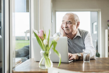 Portrait of pensive senior man looking through window - UUF006608