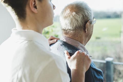 Back view of senior man and his geriatric nurse stock photo