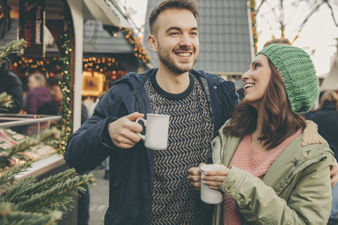 Couple having a hot punch on the Christmas Market stock photo