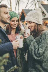 Three friends having a hot punch on the Christmas Market - MFF002674