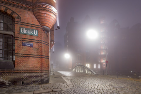 Germany, Hamburg, Fog in the Historic Warehouse district Speicherstadt at night stock photo