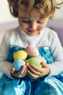 Happy little girl holding Easter eggs - MGOF001422