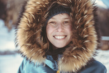 Portrait of happy woman with fur hood - MFF002711