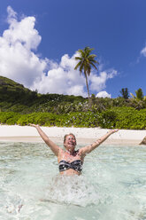 Seychellen, Anse Cocos, Touristin im Wasser - FOF008420