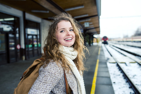 Smiling teenage girl on station platform stock photo