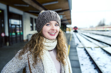 Porträt eines lächelnden Teenagers auf dem Bahnsteig - HAPF000209