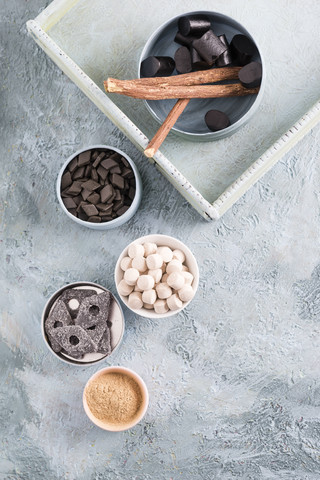 Bowls of liquorice roots and different licorice products stock photo