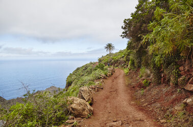 Spain, Canary Islands, La Gomera, hiker on coastal trail - RHF001289