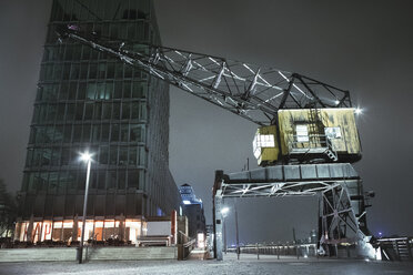 Germany, Cologne, KAP am Suedkai and harbour crane at Rhine harbour by night - MAD000795