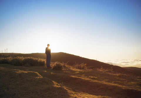 Portugal, Madeira, man looking at sunset in rural landscape stock photo