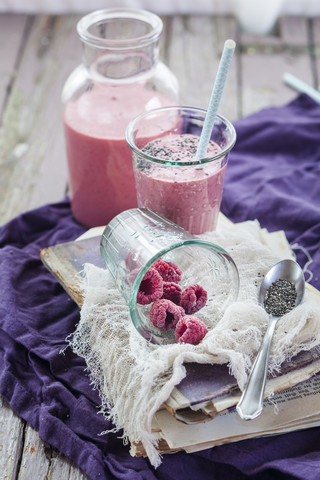 Glass and bottle of vegan raspberry smoothie stock photo