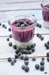 Glass of chia blueberry pudding on wood - LVF004519