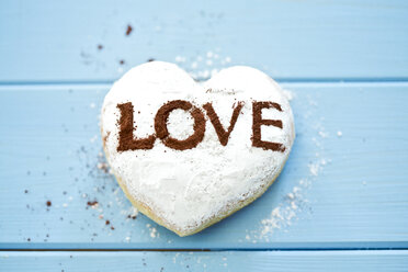 Pastry with the word 'Love' on light blue wood - MAEF011290