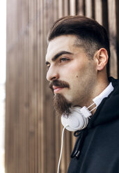 Portrait of stylish young man with headphones - MGOF001435