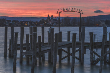 Germany, Allensbach, Pier and Church of St Peter and Paul on Reichenau Island, afterglow - KEBF000341