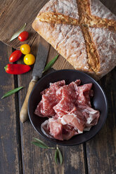 Ciabatta-Brot mit Schinken und Salami, Tomaten und Mini-Paprika auf Holz - CSF027166