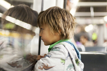 Little boy looking through window of a subway train - VABF000163