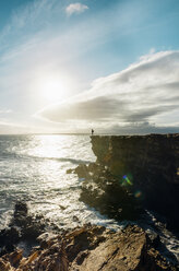 Spain, Canary Islands, Fuerteventura, La Pared, man standing on a cliff at sunset - GEMF000736