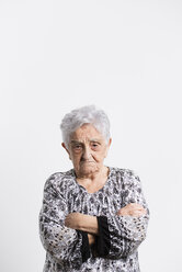 Portrait of angry senior woman in front of white background - RAEF000892