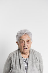 Portrait of surprised senior woman in front of white background - RAEF000899