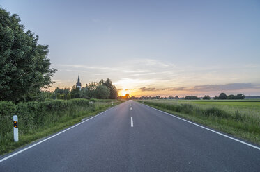 Germany, Lower Saxony, Peine, Country road at sunset - PVCF000783