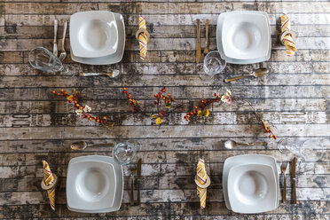 Four place settings on autumnal decorated table - SARF002571