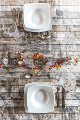 Two place settings on autumnal decorated table - SARF002572