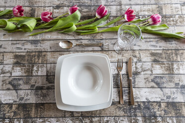 Place setting on table decorated with tulips - SARF002575
