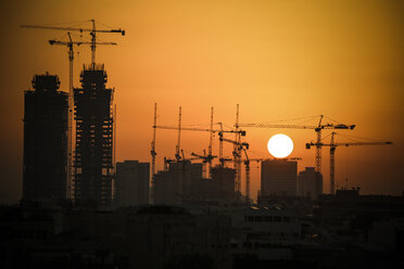 Israel, Tel Aviv, cityscape with cranes at sunset - REAF000077