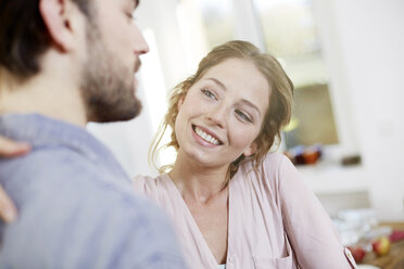 Affectionate couple in kitchen - FMKF002364