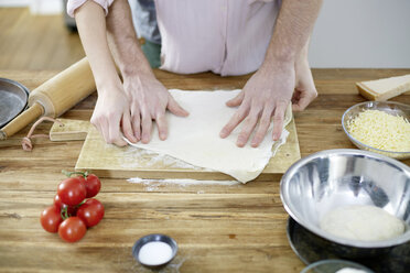 Couple preparing dough together - FMKF002394