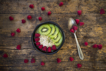 Bowl of kiwi apple rocket smoothie with chia seed, popped amarant, kiwi slices and raspberries - LVF004555