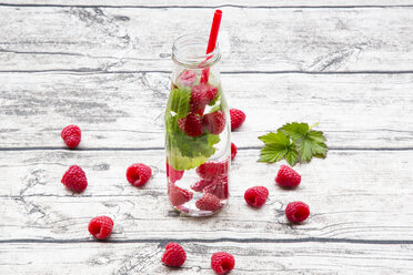 Glass bottle of infused water with raspberries and mint - LVF004558