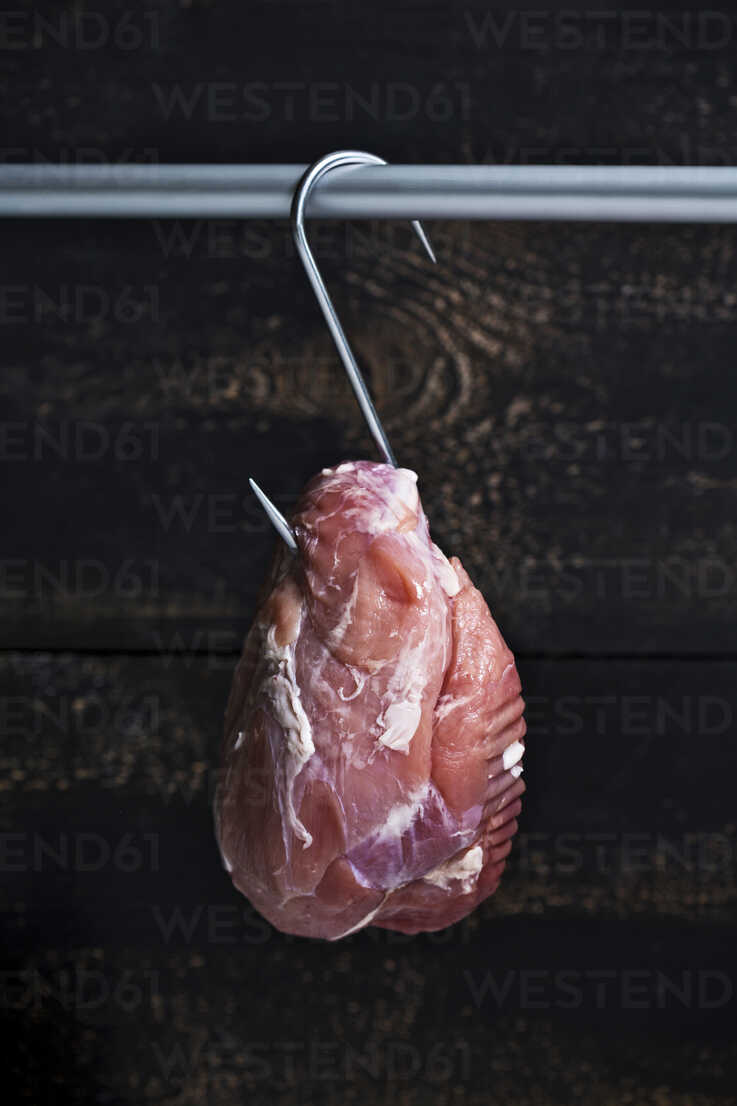 Roast pork on meat hook stock photo