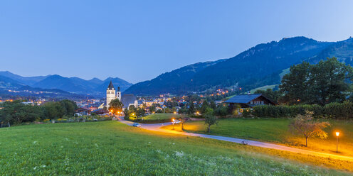 Austria, Tyrol, Kitzbuehel, townscape with churches at dusk - WDF003542